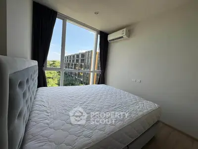 Modern bedroom with large window and scenic view in a stylish apartment