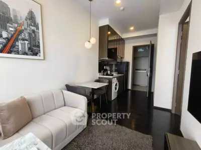Modern apartment interior with cozy living room and compact kitchen featuring washing machine.