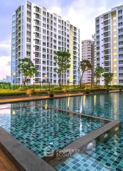 Luxurious high-rise apartments with a stunning poolside view at sunset, perfect for modern living.