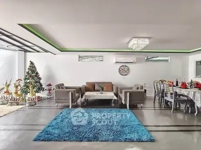 Spacious modern living room with festive decor and elegant chandelier