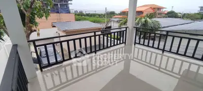 Spacious balcony with modern railing and neighborhood view, perfect for relaxation and outdoor enjoyment.