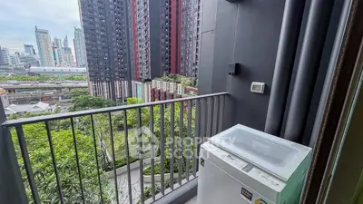 Modern urban balcony with washing machine and city skyline view