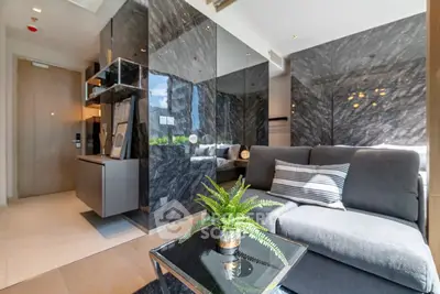 Modern living room with sleek marble walls and cozy gray sofa