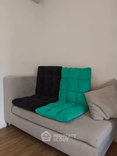 Cozy living room corner with modern sofa and colorful cushions