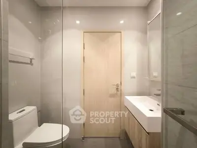 Modern minimalist bathroom with sleek fixtures and neutral tones