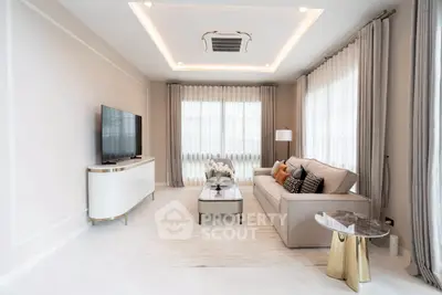 Elegant living room with modern decor and large windows