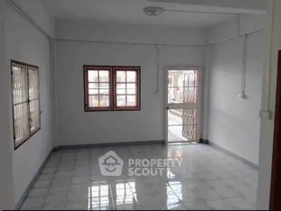 Spacious unfurnished room with tiled flooring and large windows, perfect for customization.