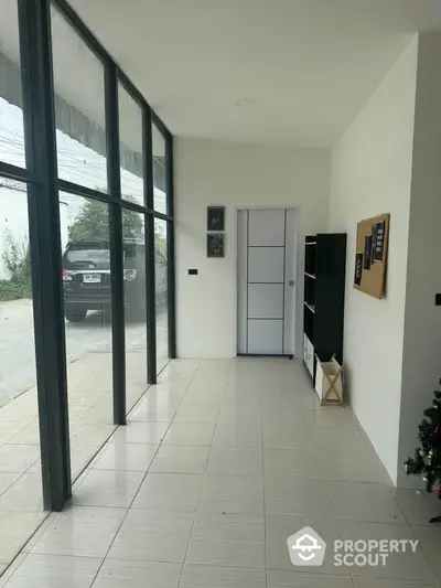 Spacious modern entrance with large windows and sleek design