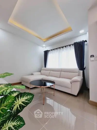 Modern living room with stylish white sofa and elegant ceiling lighting