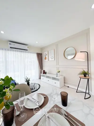 Elegant dining area with modern decor and natural light in a stylish apartment.