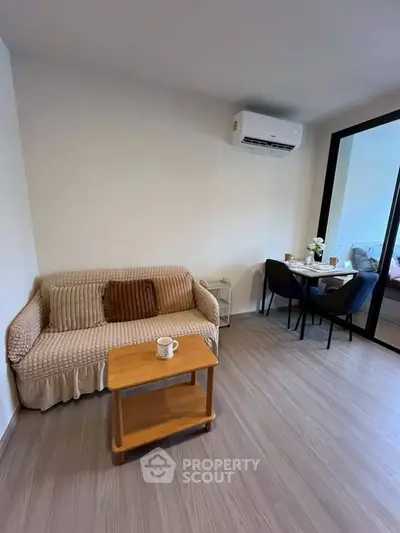 Cozy living room with modern decor and dining area, perfect for relaxation and entertaining.
