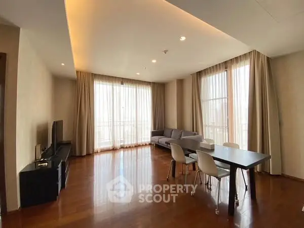 Spacious living room with modern decor and large windows for natural light