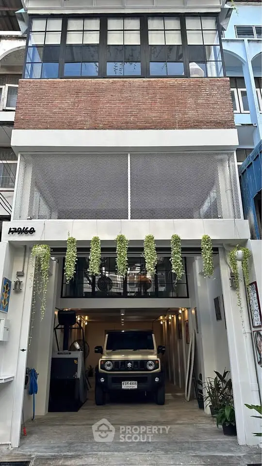 Modern urban townhouse with garage and hanging plants