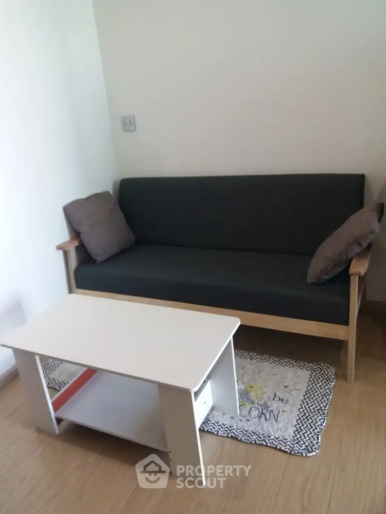 Cozy living room with modern sofa and coffee table on wooden floor
