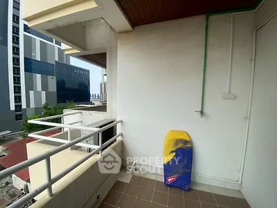 Spacious balcony with city view, perfect for relaxation and enjoying the outdoors.