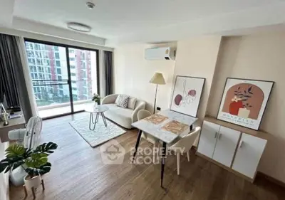 Modern living room with stylish decor and balcony view in a contemporary apartment.