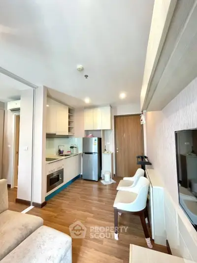 Modern apartment interior with open kitchen and cozy living area
