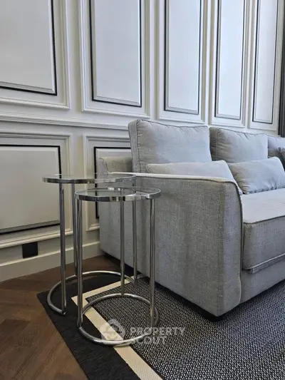 Elegant living room with modern gray sofa and stylish side tables