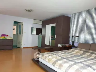 Spacious bedroom with modern decor and ample natural light