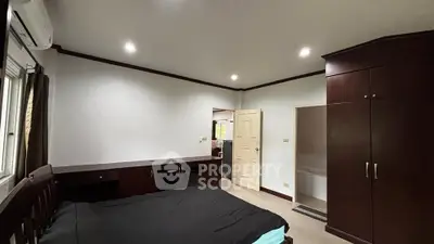 Spacious bedroom with modern furnishings and ample natural light.