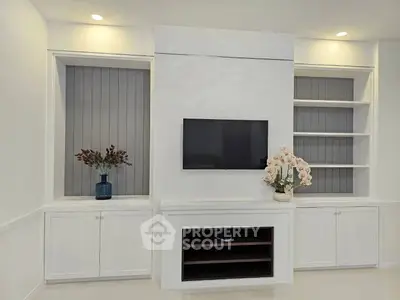 Elegant living room with built-in shelves and modern TV setup