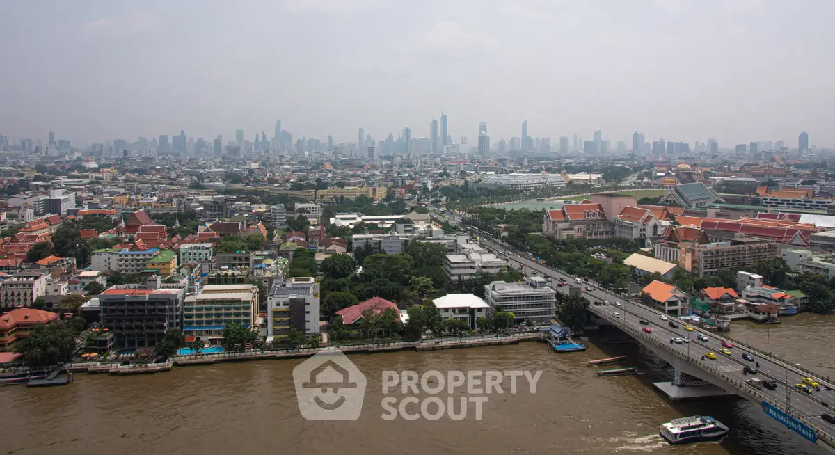 Stunning aerial view of a bustling cityscape with river and skyline, perfect for urban living enthusiasts.