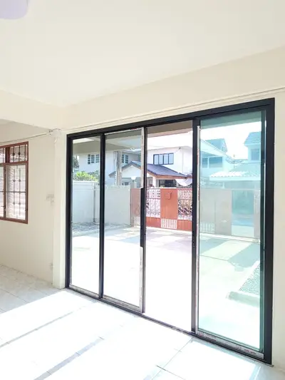 Bright and airy living space with large sliding glass doors opening to a serene residential view.