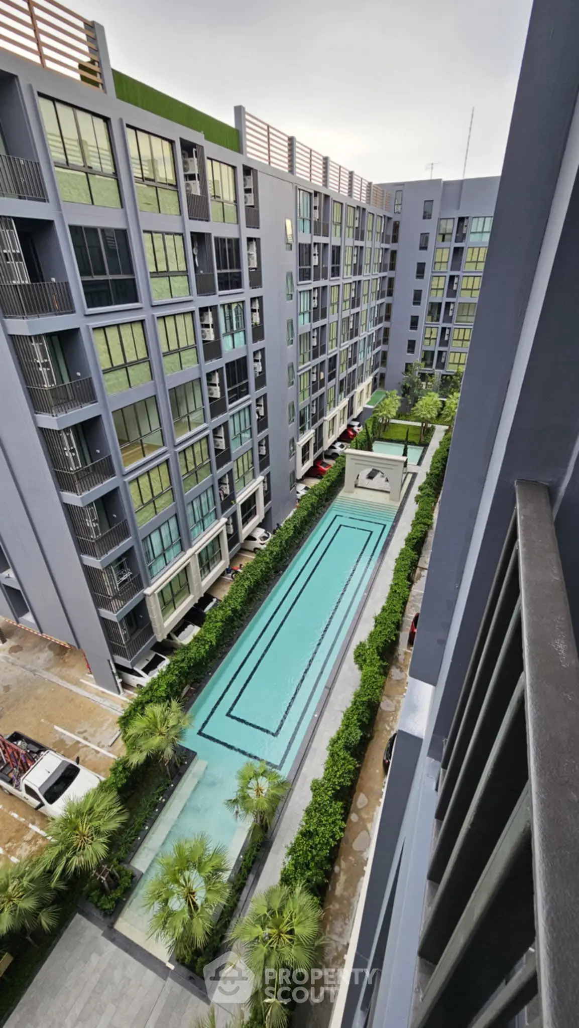 Modern apartment complex with a stunning central swimming pool view.