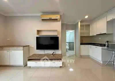 Modern living room with sleek kitchen and air conditioning in a stylish apartment.