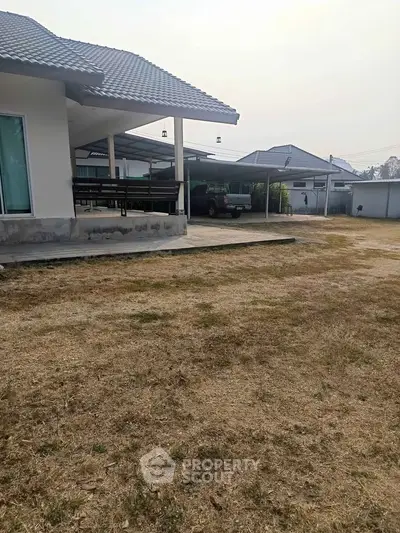 Spacious suburban property with ample outdoor space and covered parking area.