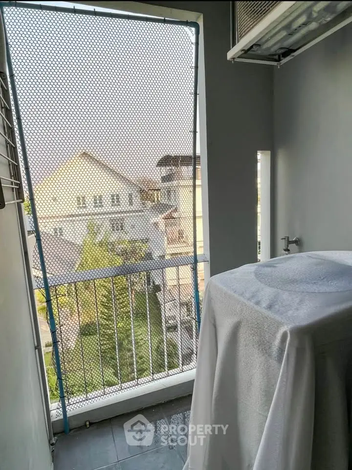 Charming balcony with a view of residential neighborhood, perfect for relaxation and enjoying fresh air.