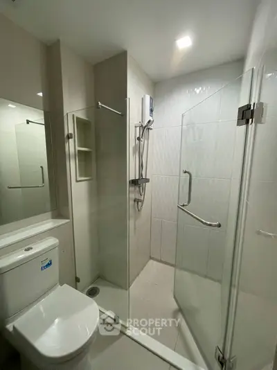 Modern bathroom with glass shower and sleek fixtures