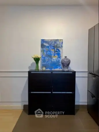 Modern interior with stylish cabinet and artistic decor in a contemporary home setting.