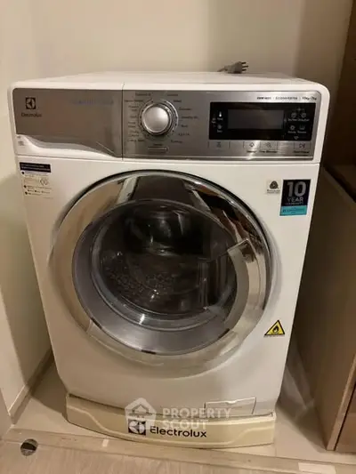Modern Electrolux washing machine in a stylish laundry area, perfect for efficient home living.