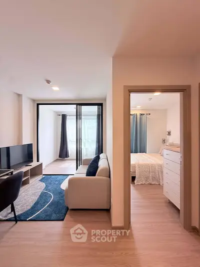 Modern apartment interior with cozy living room and bedroom, featuring stylish furniture and natural light.