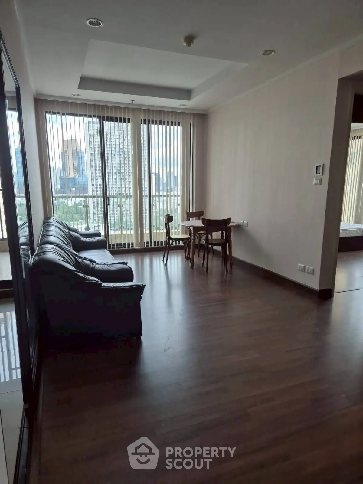 Spacious living room with city view and modern furnishings