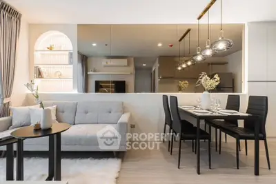 Modern open-plan living room with stylish dining area and elegant lighting.