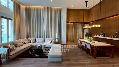 Luxurious living room with high ceilings, elegant lighting, and modern decor in a spacious open layout.