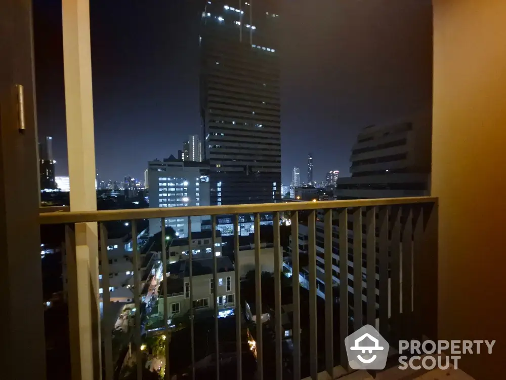 Stunning cityscape view from a modern balcony at night, perfect for urban living enthusiasts.