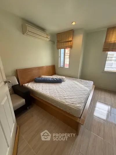 Cozy bedroom with natural light and air conditioning in modern apartment