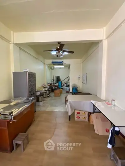 Spacious interior with ceiling fan and open layout, ideal for versatile use.