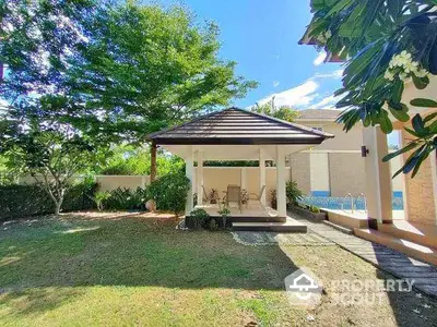 Charming garden with gazebo and lush greenery in a serene residential setting