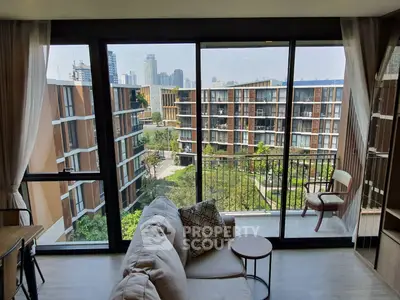 Spacious living room with large windows offering a stunning city view, modern furniture, and elegant decor.