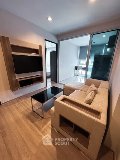 Modern living room with sleek furniture and large TV in stylish apartment