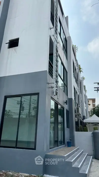 Modern multi-story building with large windows and sleek design