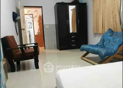 Spacious bedroom with modern furniture and ample natural light