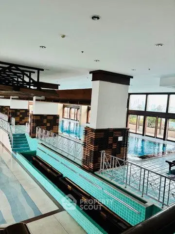 Luxurious indoor swimming pool with elegant design and city views, perfect for relaxation and leisure.