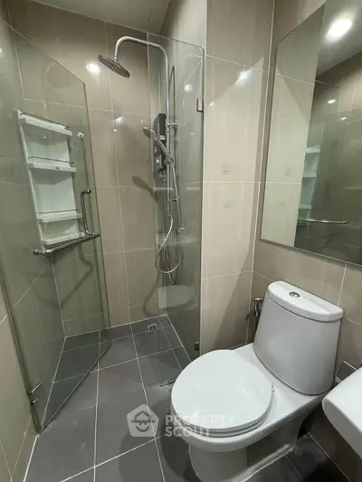 Modern bathroom with glass shower enclosure and sleek fixtures