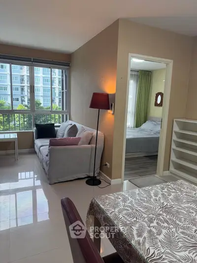 Modern apartment interior with cozy living room and bedroom view, featuring stylish decor and ample natural light.