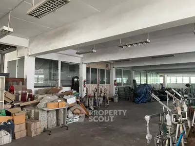 Spacious industrial warehouse with ample storage and natural light, ideal for manufacturing or distribution.